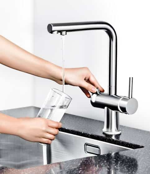 faucet with water filter pouring into a cup