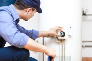 a home climates employee serving a water heater in Lancaster Pennsylvania