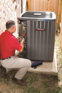 Technician performing AC maintenance