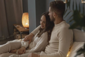 Cozy couple on couch.