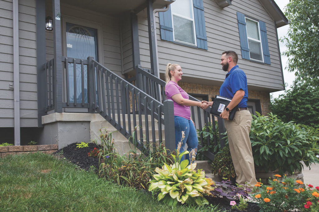 HVAC technician speaking with customer