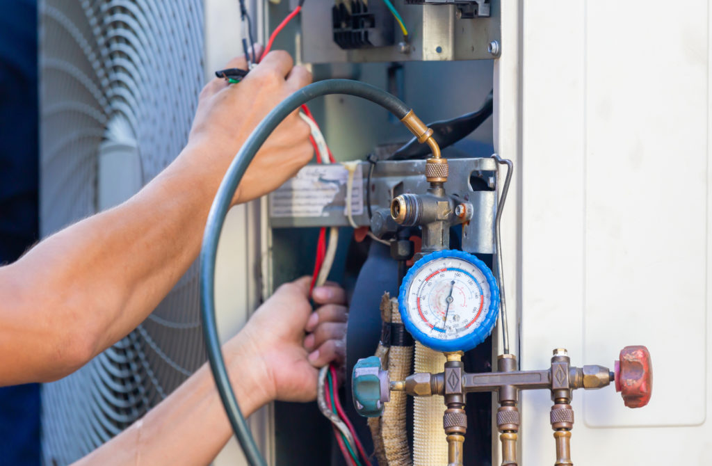 HVAC technician repairing equipment