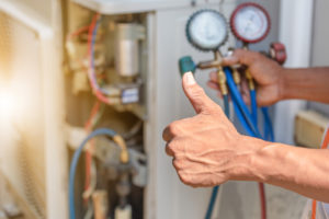 Technician providing air conditioning repair service