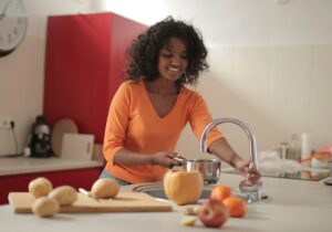 woman works in kitchen preparing meal