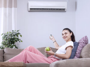 woman using AC remote control