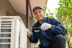 air conditioning technician works on AC unit