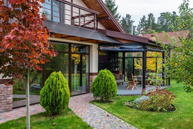 Outside of a house during the fall|furnace repairs happy family|oil to gas conversion happy family|home in autumn with colorful trees