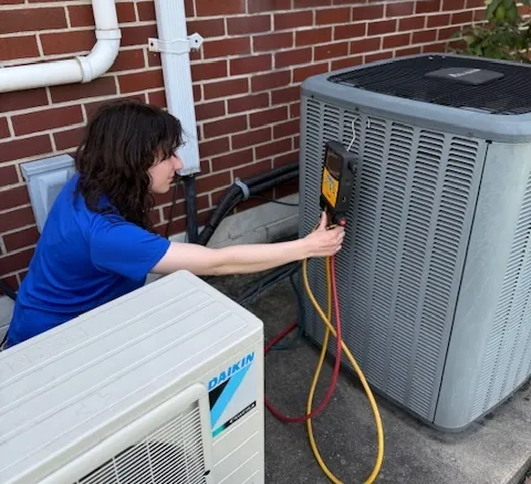 Home Climates HVAC technician servicing a system