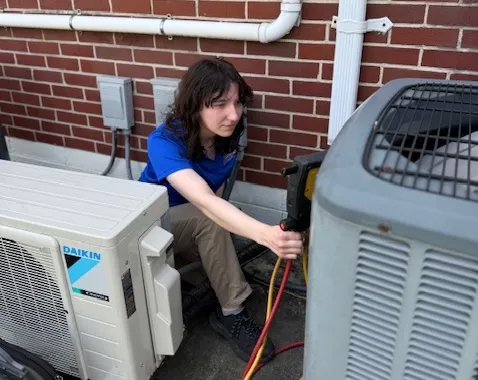 tech Home Climates HVAC technician servicing a system